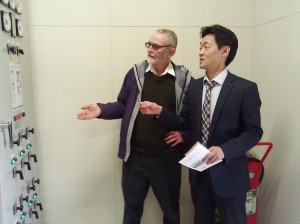 Leo Bosner and Yasuyuki Matsumoto of NEXCO examine emergency power equipment at NEXCO highway rest area, March 2015